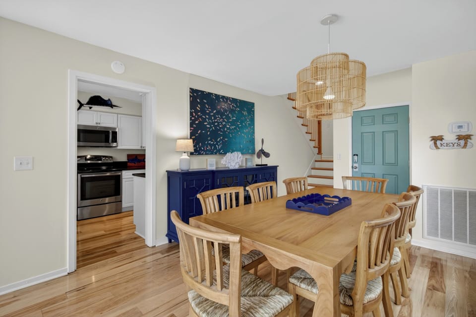 Gather around the handcrafted wood table where meals become memories, surrounded by coastal charm and ocean-inspired art that sets the perfect tone for your beach escape.