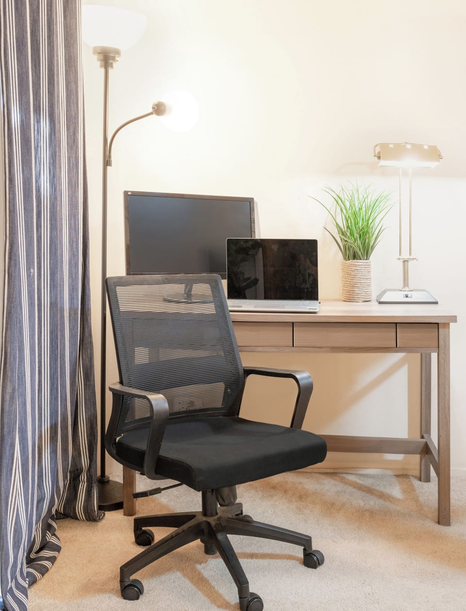 Private workspace in the primary bedroom—dedicated desk, ergonomic chair, and large external monitor provided