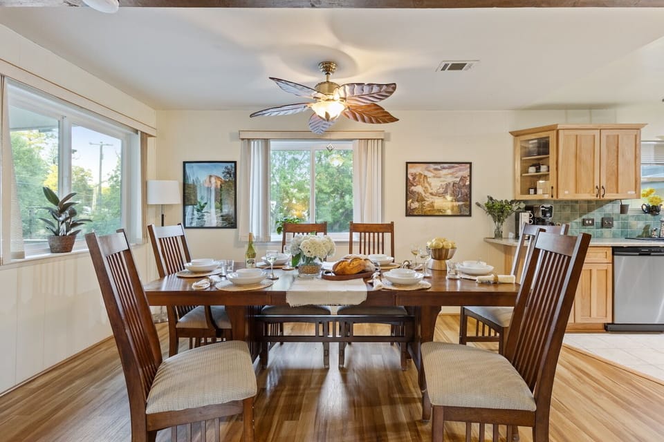 Formal dining table seating 10,  made for lingering breakfasts, family dinners, and game nights. Located off the kitchen and living room 1.