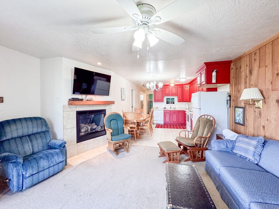 Cozy lakeside retreat with fireplace, open living space, and cheerful kitchen for gathering together.