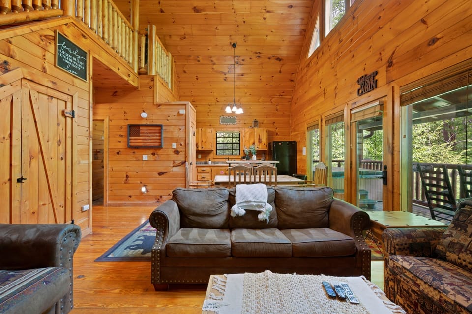 Cozy sitting area off the great room — leather seating and warm cabin styling
