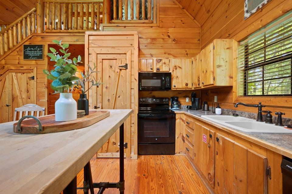 Kitchen island / breakfast bar with seating, prep space, and full-size appliances