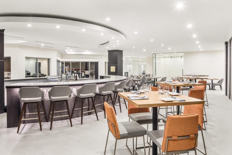 Sip and socialize in a stylish bar and dining space.