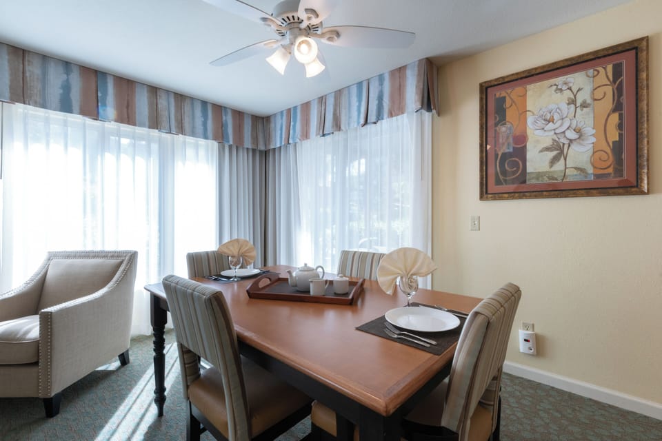 Gather for sunny meals beside soft, wall-to-wall window sheers.