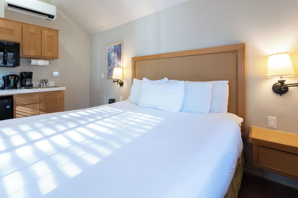 Stretch out on a roomy king bed with warm lighting.