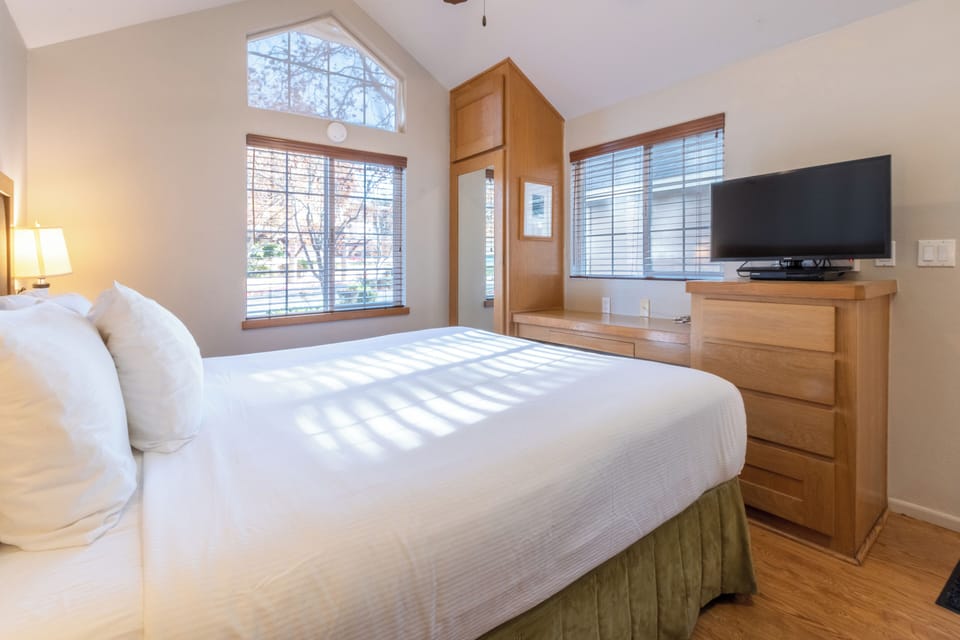 Unwind in sunlit comfort with crisp linens and TV.