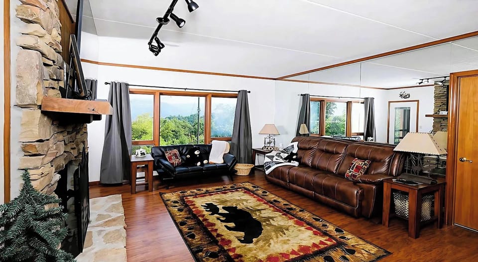 Cozy, open living room w/ smart TV, fireplace, and sun-porch access