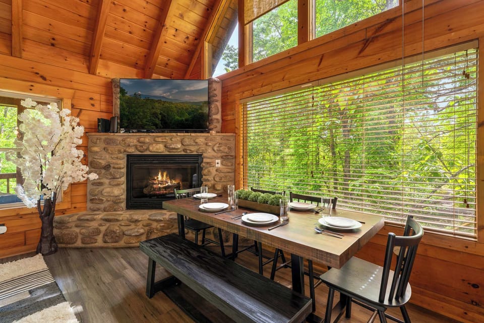 Dining with forest views by stone hearth