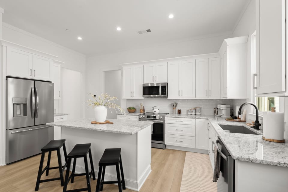 Bright modern kitchen with island seating and sleek stainless appliances