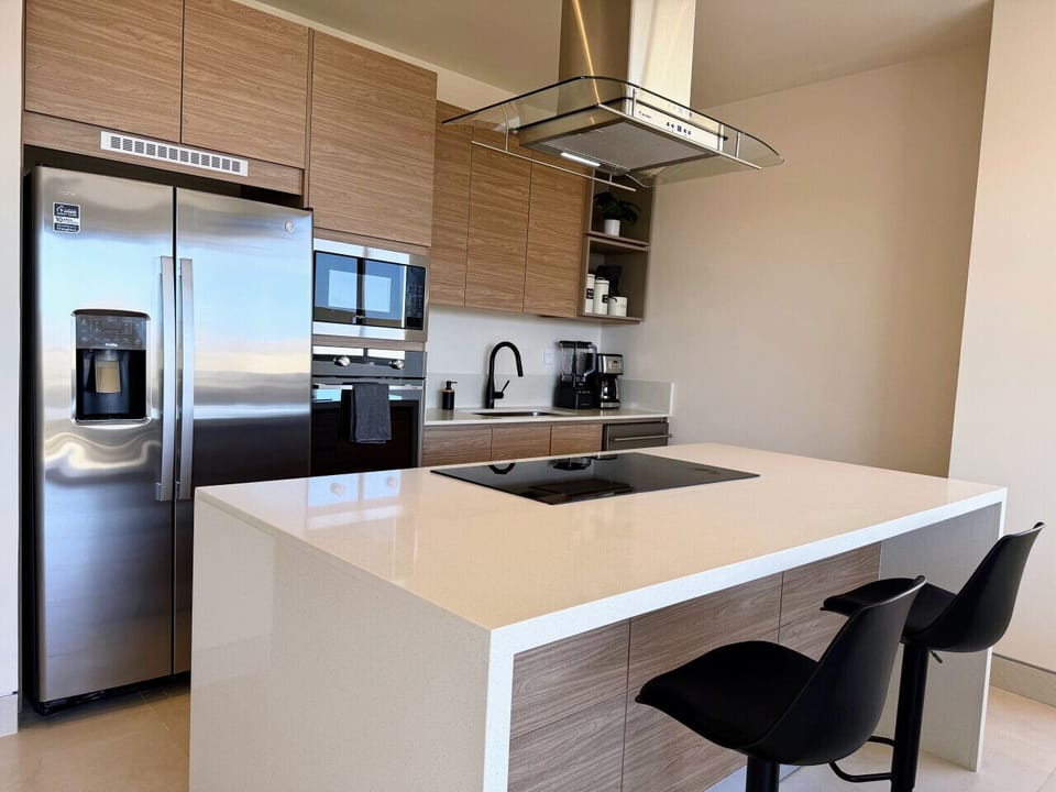 Fully equipped kitchen with modern appliances and breakfast bar.
