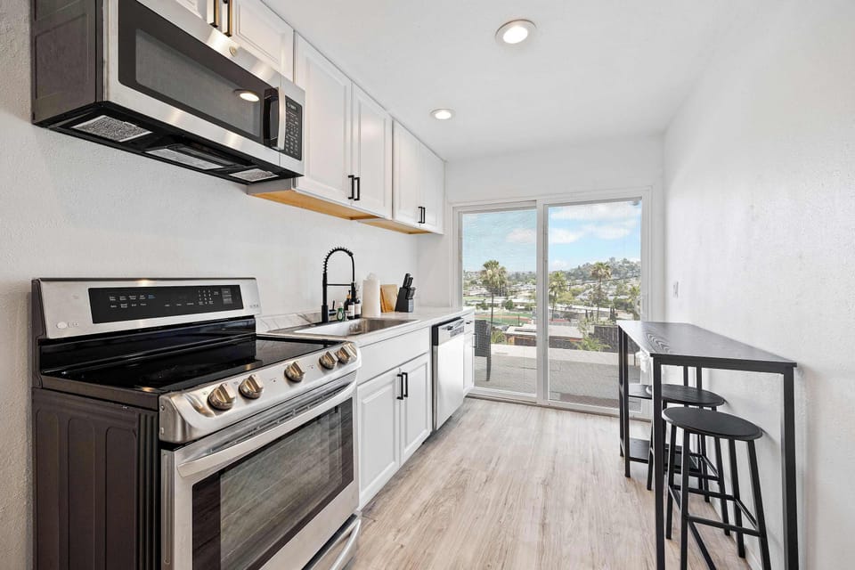 Bright modern kitchen with scenic hillside views ✨