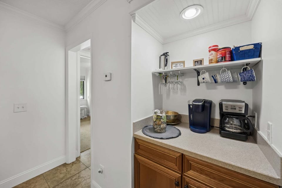 Enjoy the in-unit coffee bar with both drip and pod coffee makers, plus mugs, glassware, and extra counter space—perfect for morning coffee or evening drinks during your stay.