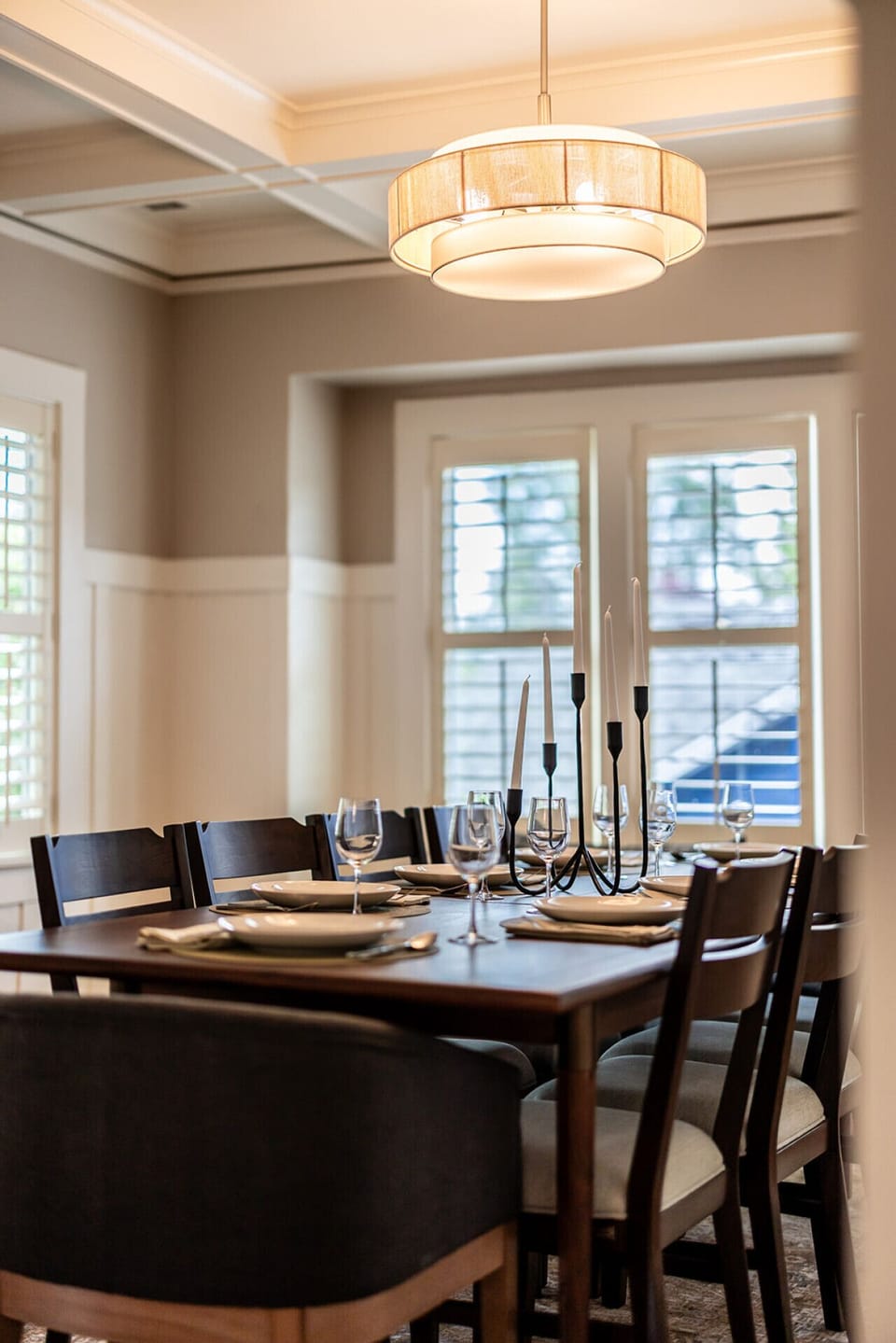 Main floor dining table set for a dinner party with candelabras and wine glasses