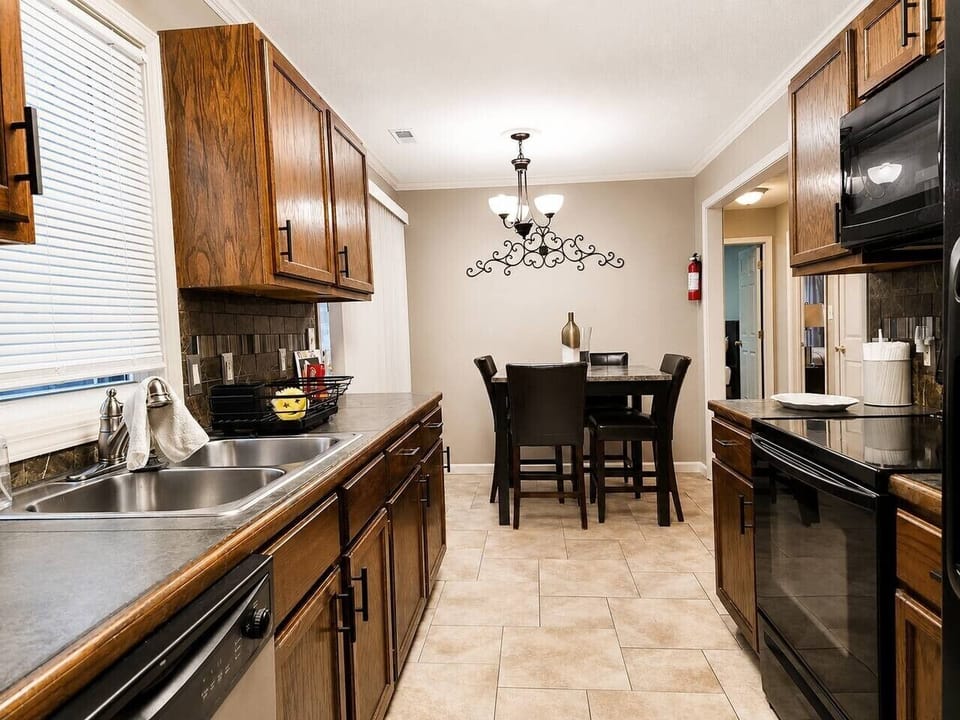 Spacious kitchen with dining table and full-size appliances