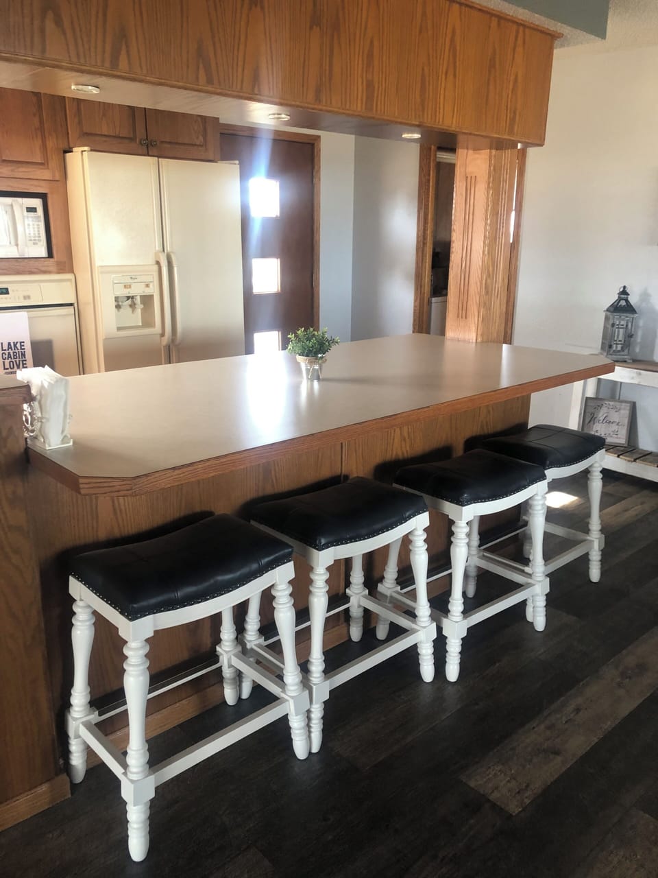 Four saddle bar stools at the kitchen bar.