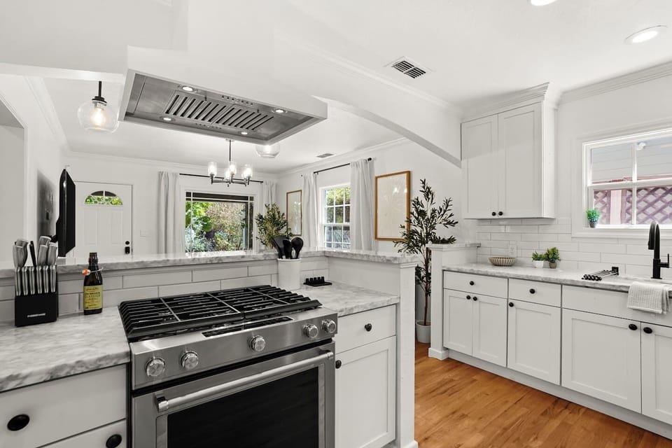 Fully equipped kitchen with modern appliances, stocked coffee bar, ample prep space, and everything needed to cook at home.