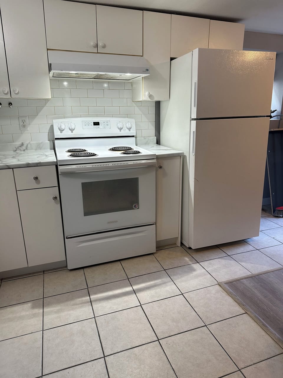 Full kitchen with fridge, freezer, stove , microwave and dining table and chair