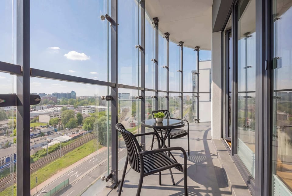 Balcony with outdoor seating and panoramic cityscape view