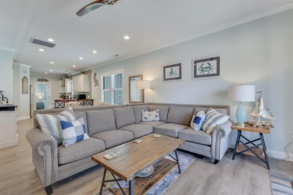 Sink into this cozy sectional after a day of coastal adventures. The nautical-inspired living room flows into the kitchen, creating your perfect space to gather and unwind.