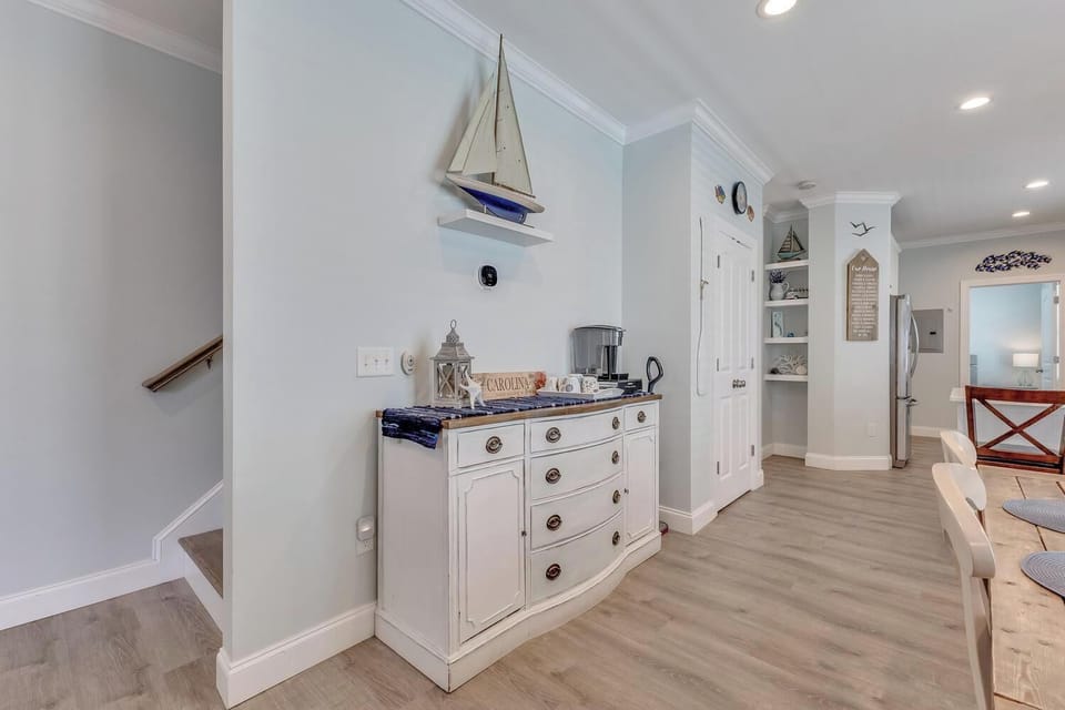 A charming coastal-inspired space with a coffee station ready for your mornings, featuring beach decor and easy access to the rest of your vacation home.