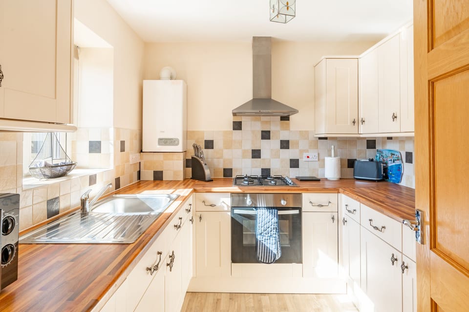 Ground floor: Kitchen with electric oven and gas hob, microwave, dishwasher and fridge-freezer