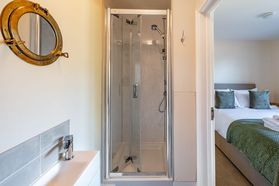Ground floor: En-suite shower with shower, wash basin and WC