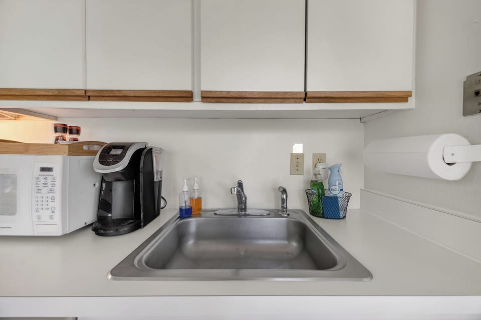 Your kitchenette is fully stocked with everything you need—coffee maker, microwave, sink, and essentials—making it easy to prepare snacks or enjoy a morning brew at your own pace.