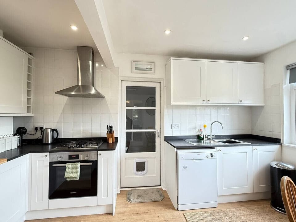 Kitchen with access to utility area and side entrance
