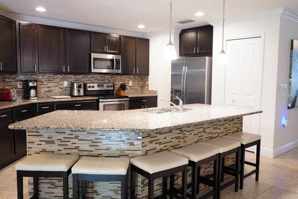 Gather around the beautiful kitchen island, perfect for cooking and casual dining with family and friends.