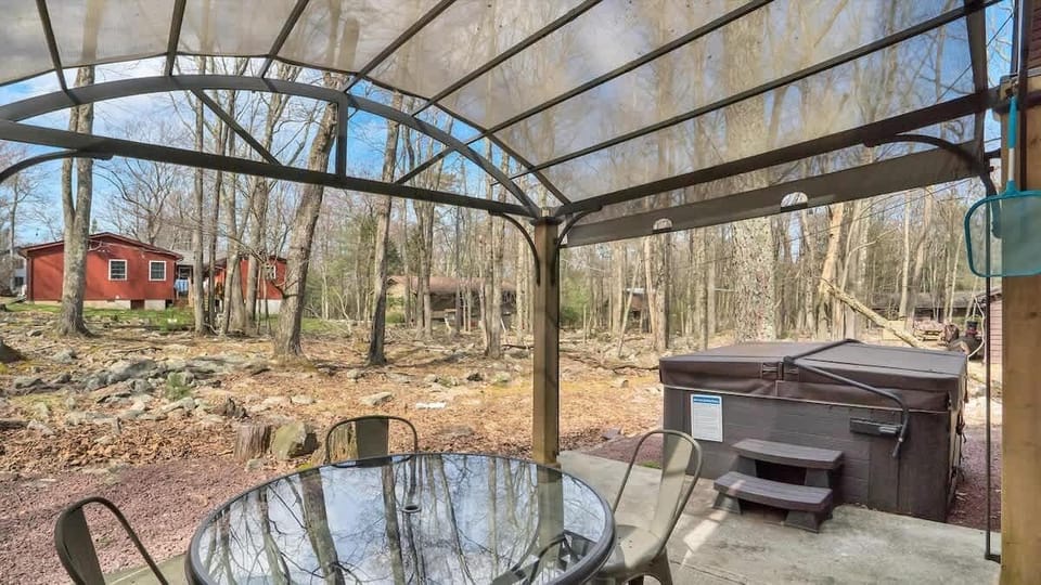 Covered Outdoor Dining Area with Hot Tub & Forest Views