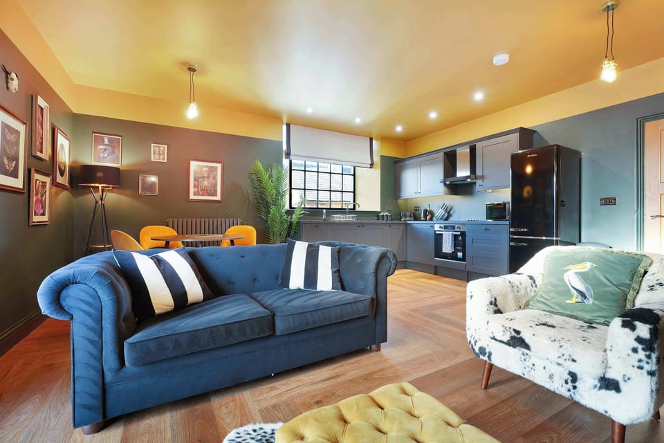 Kick back in the stylish living area featuring a comfortable 2-seater sofa, two armchairs and a Smart TV, perfect for unwinding after sightseeing.