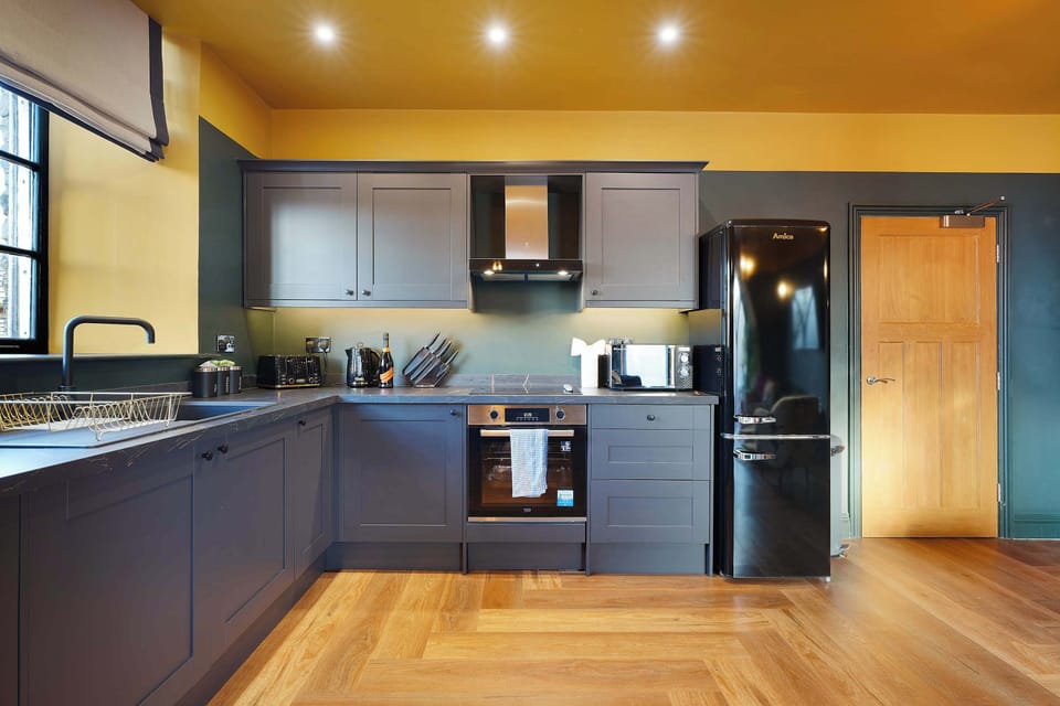 The fully equipped kitchen includes an electric hob, oven, fridge/freezer, microwave and dishwasher, offering all the essentials for preparing home-cooked meals throughout your stay.