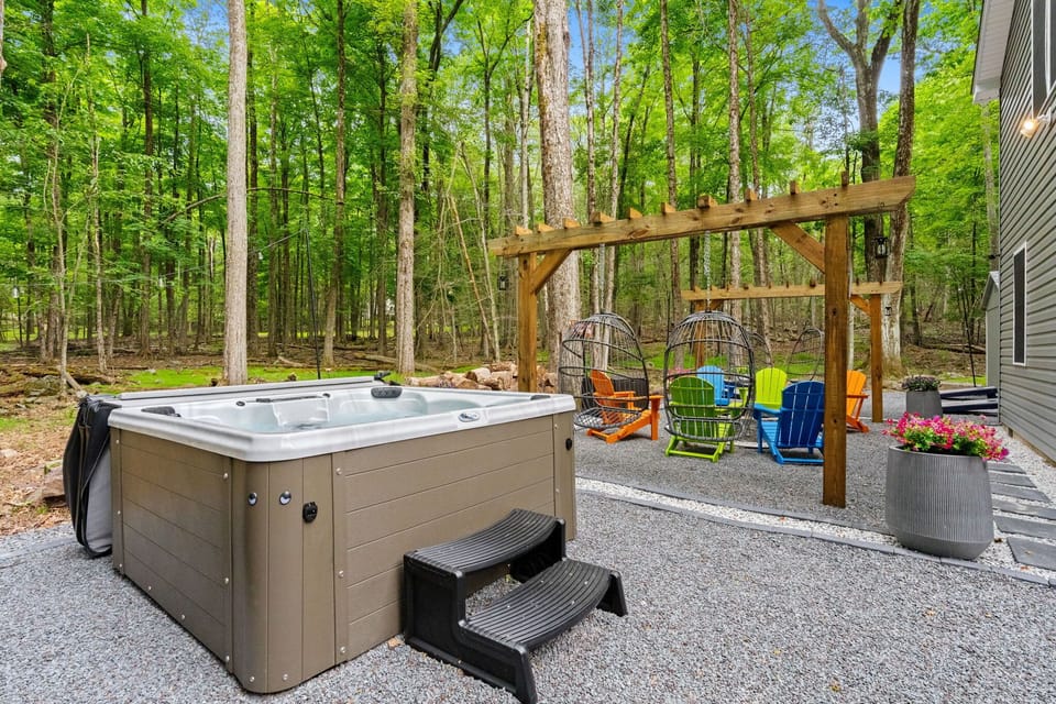 Private backyard pergola and fire pit area nestled in Pocono woodland