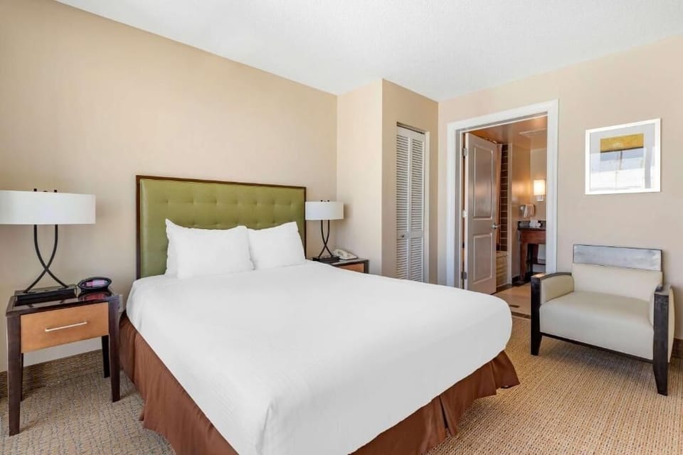 Settle into crisp linens and a calm, cozy sleeping space.