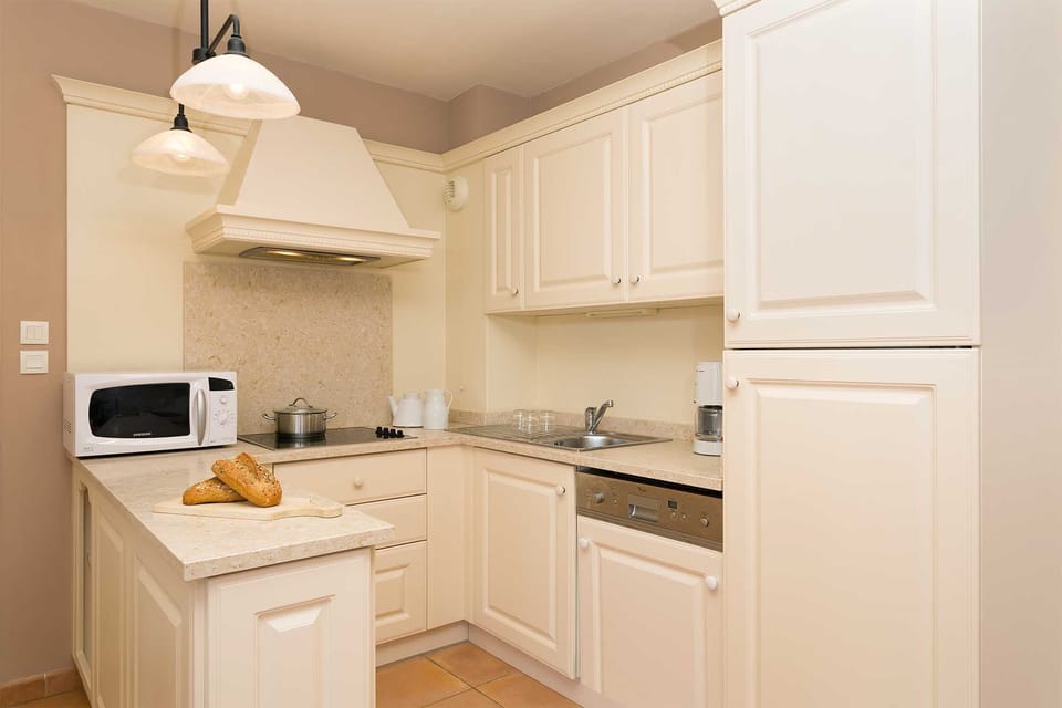 Well-appointed kitchen with all the essentials, including microwave, fridge and ample storage.