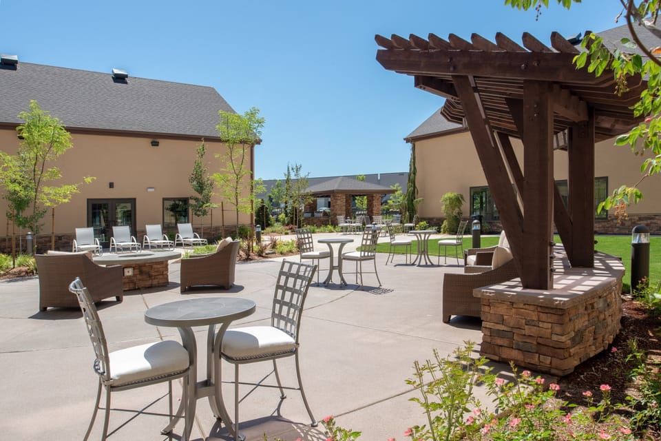 Outdoor courtyard with seating and landscaped greenery.