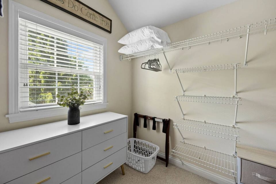 Spacious walk-in closet filled with natural light. Plenty of shelves and drawers to help you keep your things organized. Luggage racks, laundry basket, hangers, and extra pillows also available for your use.