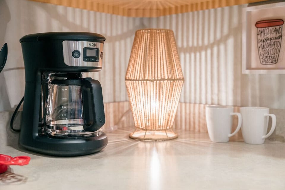 Mr. Coffee 12 cup drip coffee maker. Grinder available for fresh beans. Coffee and tea provided.
