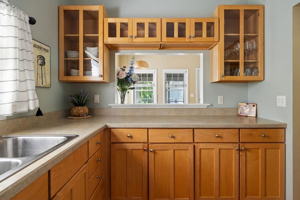 Dinnerware is available in glass cabinets and in cabinet by fridge. Pass through window ideal for serving and seeing your family and friends while dining.