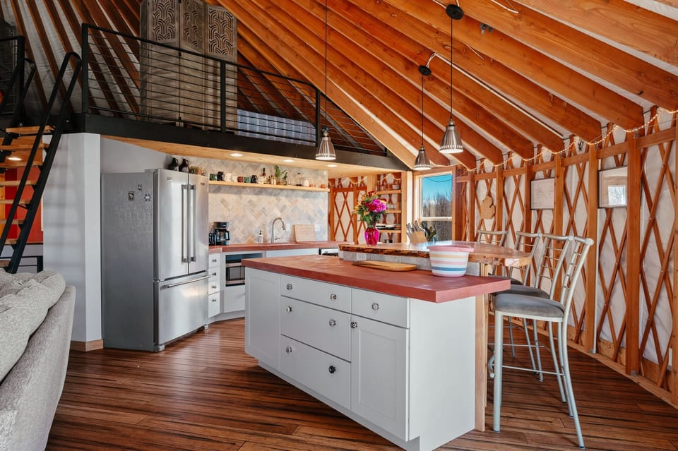 Beautiful open-concept kitchen featuring custom countertops, modern appliances, and a spacious island perfect for gathering, cooking, and entertaining.