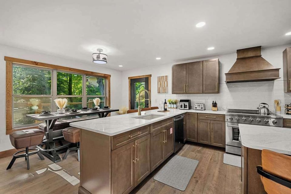 Spacious kitchen with large dining space and extra barstool seating.