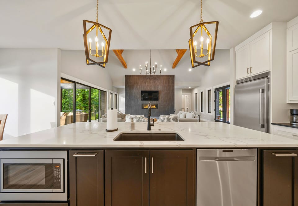 The open-concept kitchen offers ample prep space, custom cabinetry, and a layout designed to make hosting effortless.