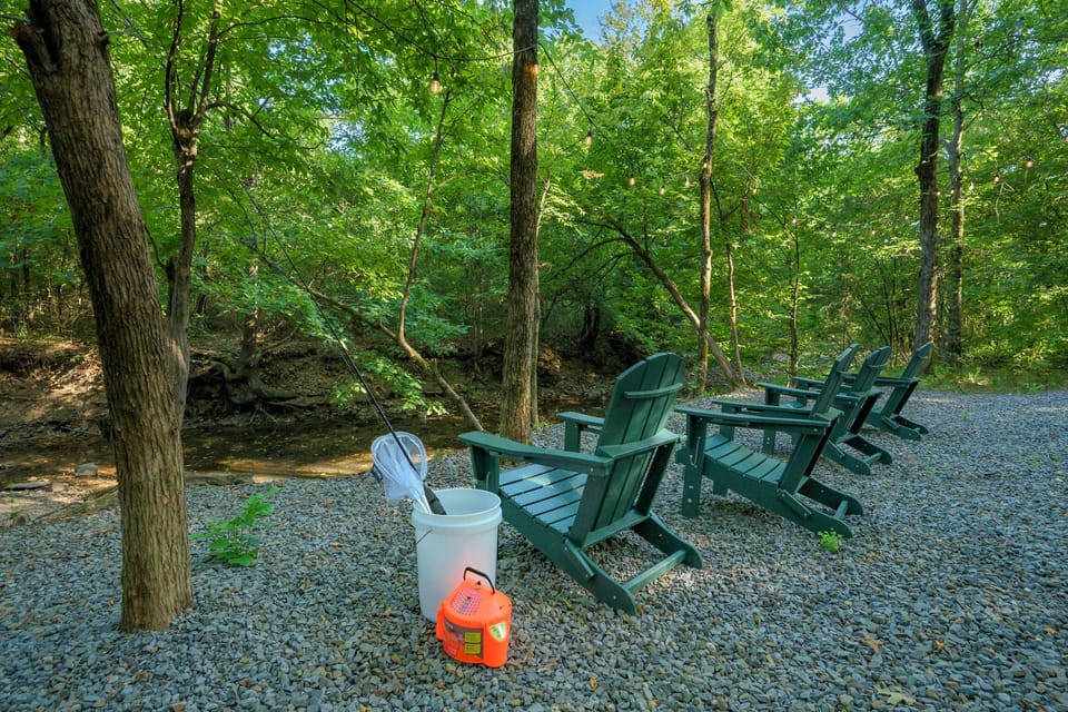 Creekside Adirondack chairs in a private, peaceful wooded retreat