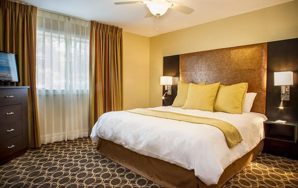 Relax into a serene king bed with cozy accent pillows.