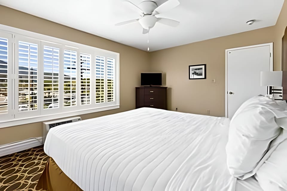 Wake up refreshed in a bright bedroom with plantation shutters.