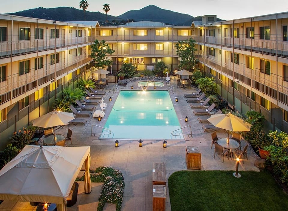 Unwind at dusk as the courtyard pool glows softly.