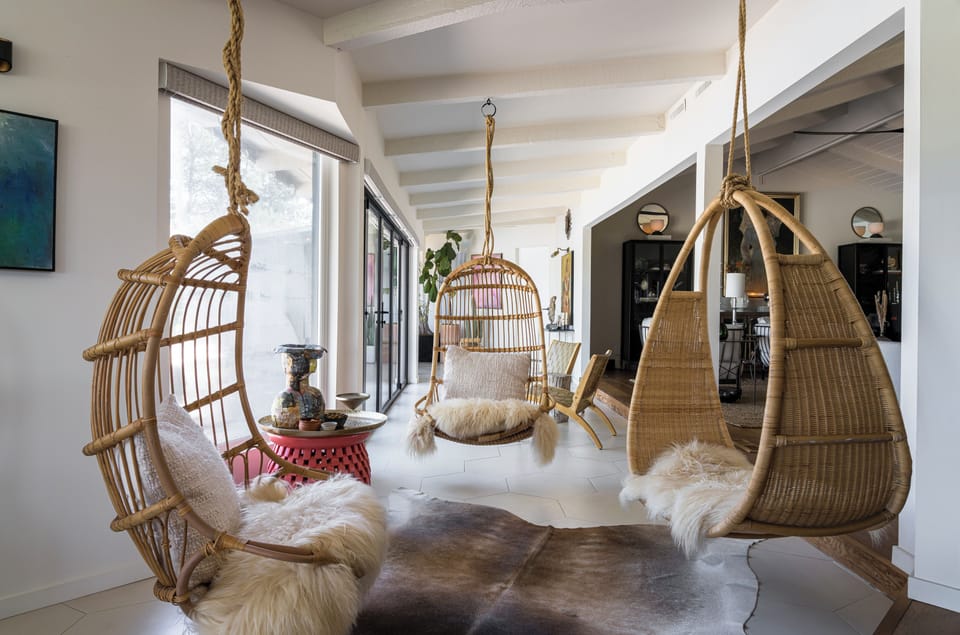 Unwind in your own bohemian sanctuary, where handcrafted hanging chairs invite you to sway gently while soaking in natural light and artistic touches throughout the space.
