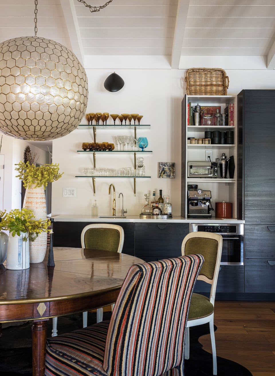Gather around this charming dining space flowing into your modern kitchen, where elegant details and thoughtful design invite you to prepare meals and share stories over coffee.