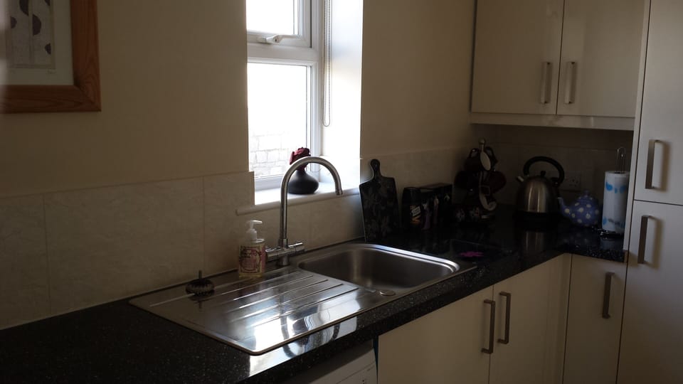 Kitchen with microwave, over, washing machine and dishwasher