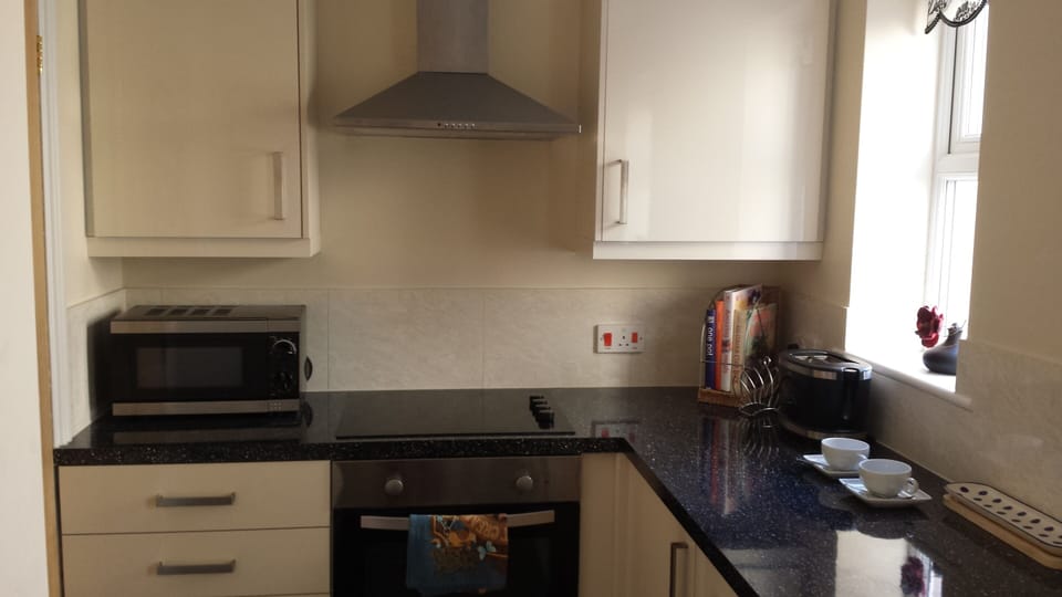 Kitchen with microwave, oven, washing machine and dishwasher